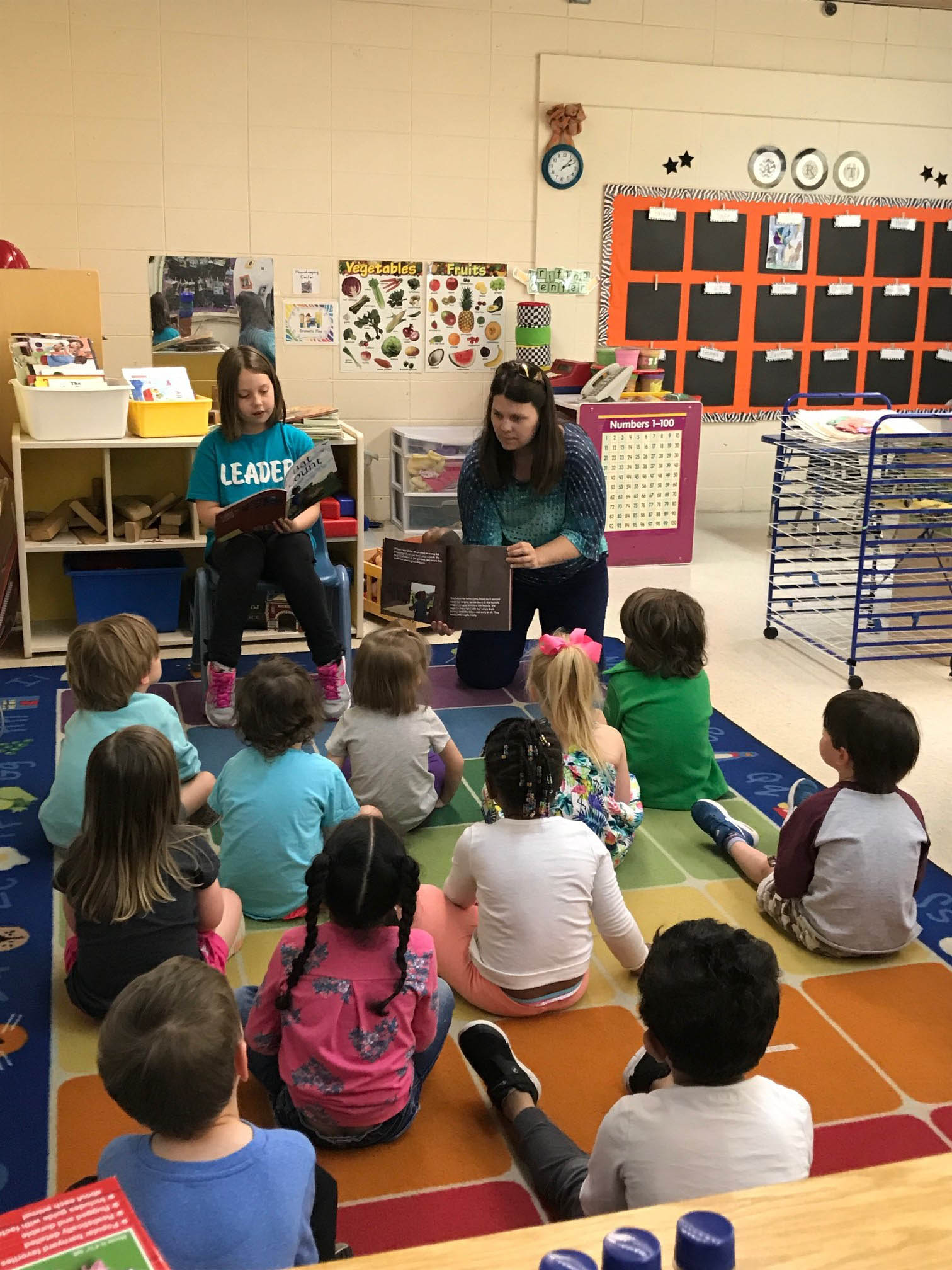 Amy Moe-Hoffman, Collections Manager and Giverny Exhibit Designer, reads the 2018 Giverny Award-winning book, Bat Count: A Citizen Science Story, as her daughter Margot Hoffman shows the illustrations to the students.