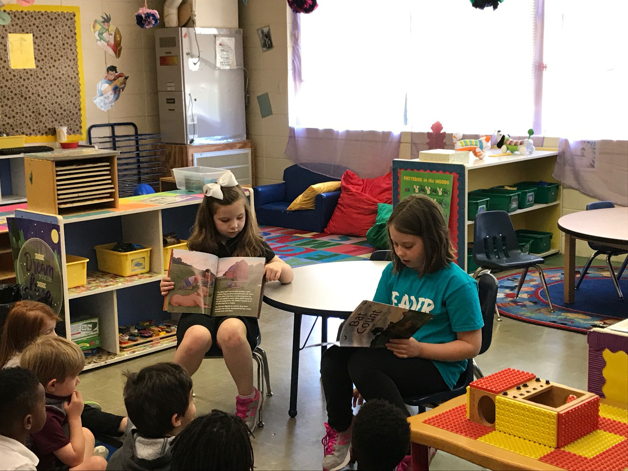 Margot Hoffman reads the Giverny book to a class, while Mary Mack Walker shows the book's illustrations to the students.