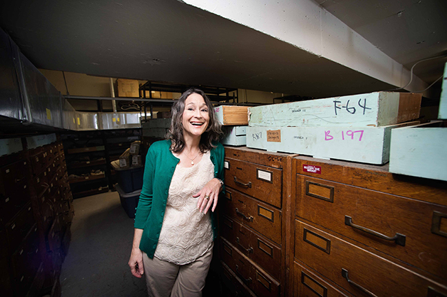 Museum Director, Renee Clary, has a laugh in the collection. Photo by Megan Bean