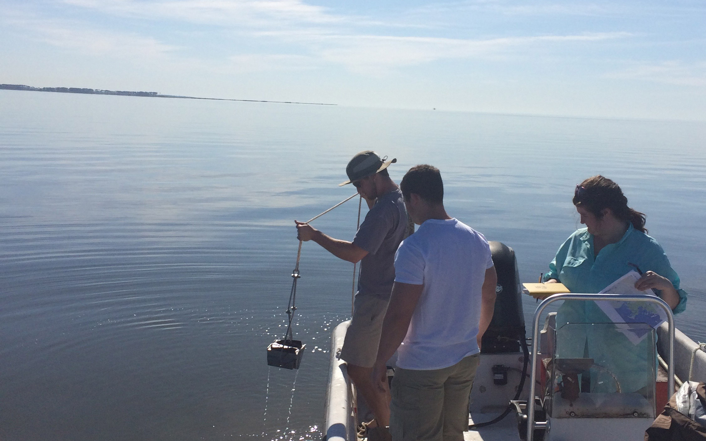 Students collect seafloor sediment samples in the Mississippi Sound