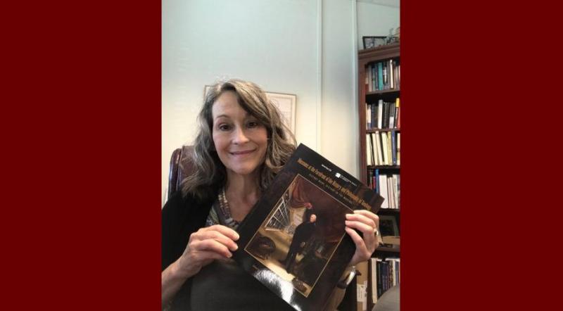 Dr. Clary holding a copy of her recently published book. 