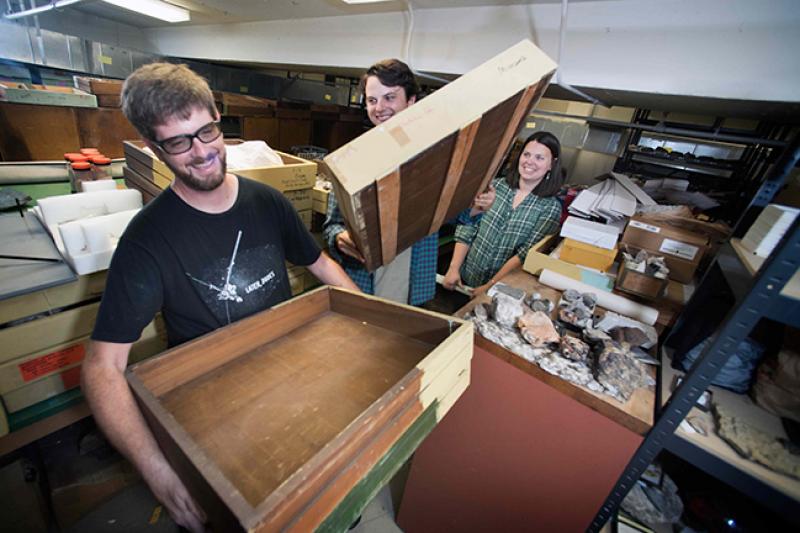 Cory and Travis receive drawers from collections manager, Amy Moe-Hoffman. Photo by Megan Bean