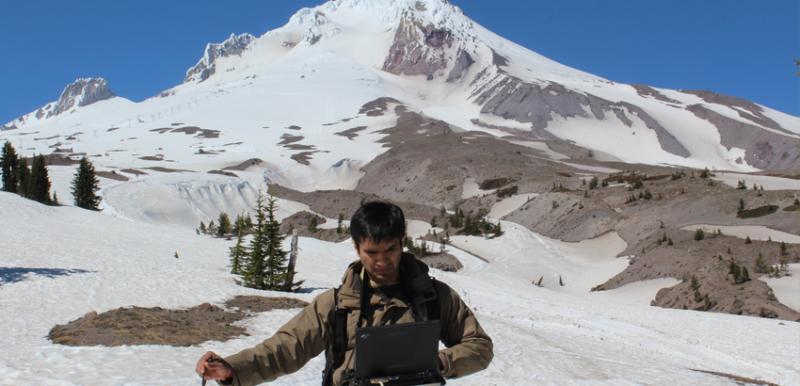 Dr. Ambinakudige photo of his Ph.D. student Pushkar Inamdar collecting spectral data during their recent visit to the Mt. Hood, and Mt. Rainier.