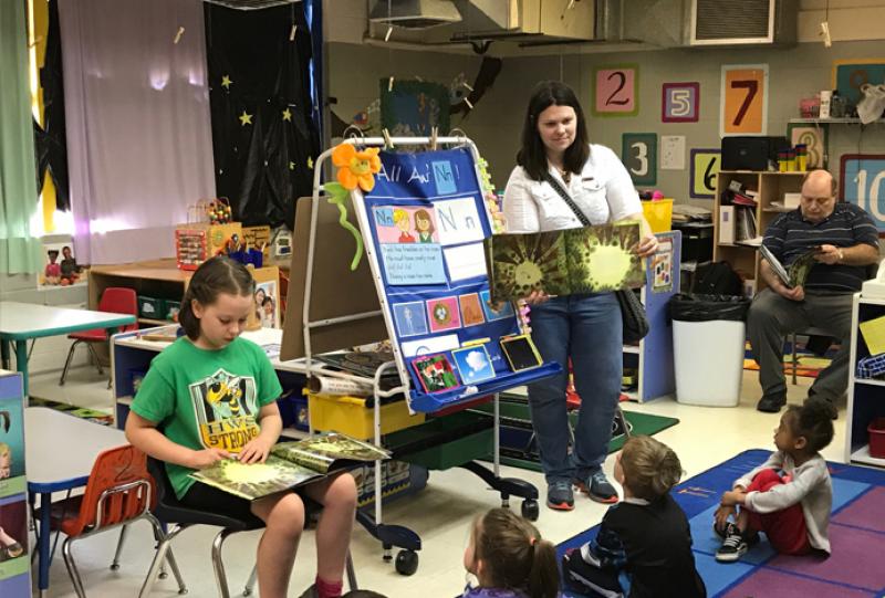 Margot Hoffman reads the 2017 Giverny book, The Tree Lady, to a class of preschoolers at Emerson Family School while her mother,