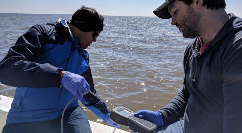 Dr. Dash (left) and his student, Landon Sanders (right), collecting profiles of salinity, temperature, dissolved oxygen, and pH 