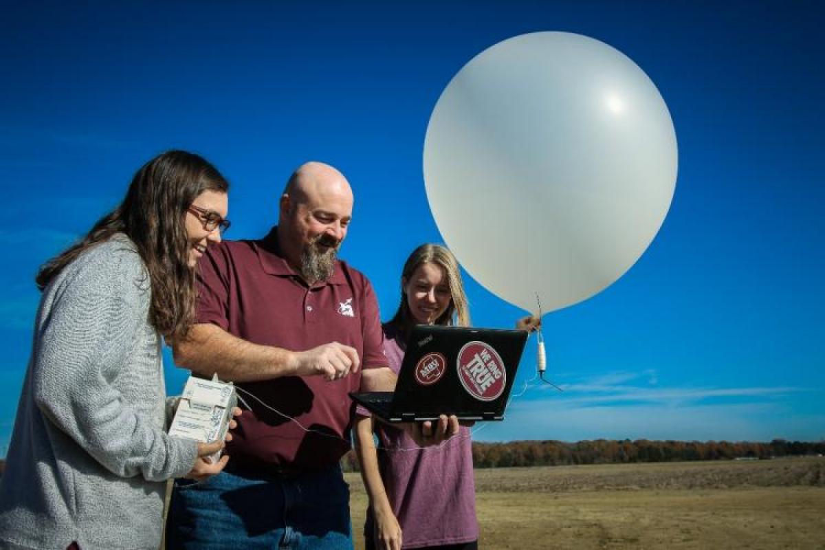 Meteorology faculty and students launching a weather balloon.