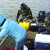 Dr. Dash and his students collecting remote sensing samples from a boat.